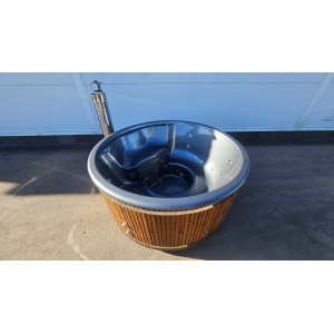 Round fiberglass hot tub with integrated heater